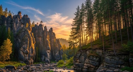 Rocky peaks bathe in sunset gold, river flowing through a tree-lined canyon landscape