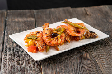 Frying shrimp with vegetables on a grill. Shrimp. Chinese cuisine. Asian food. Food concept.