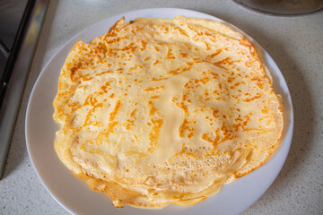 Homemade Crepe on White Plate in Home Kitchen — Thin Pancake Top View