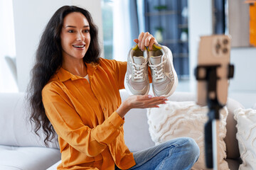 Woman vlogger reviewing sneakers for social media live stream