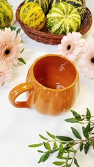 Autumn Composition with Pumpkin-Shaped Mug and Decorative Gourds