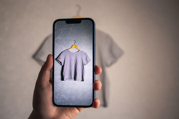 Woman photographs her old outfits for resale. Online resale platforms. Save planet and ecology concept.