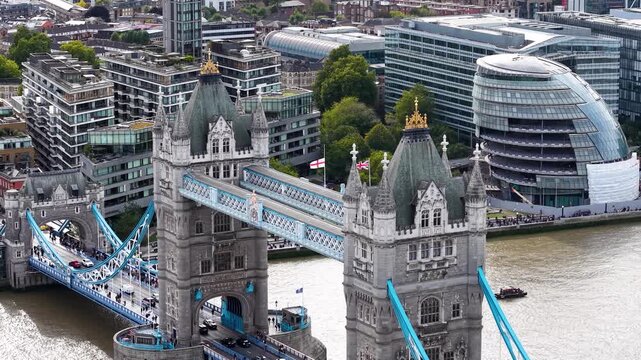Cinematic aerial view of Tower Bridge (London Bridge) and the historic Tower of London with the stunning City of London skyline and its iconic modern architecture.
