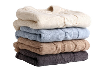 Stack of four folded cable knit sweaters in cream blue tan and grey isolated on a transparent background