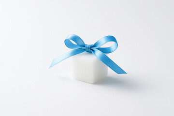Sugar Cube with Blue Ribbon on White — Diabetes Awareness Concept