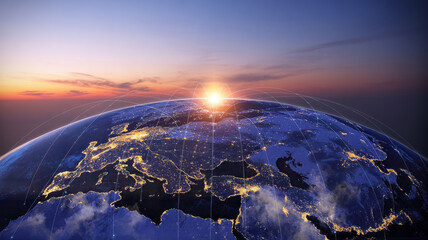 Sunrise over the earth, showing city lights and clouds satellite