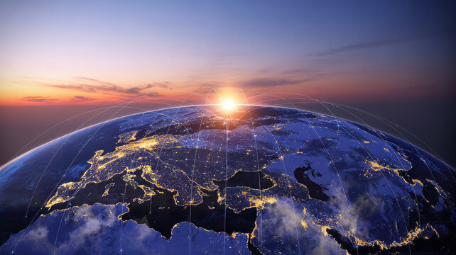 Sunrise over the earth, showing city lights and clouds satellite