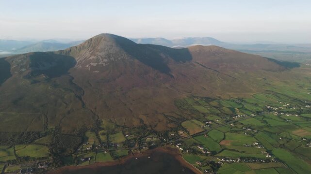 Amazing 4K aerial video of flying above and around Most Famous mountain in Ireland - Croagh Patrick in windy weather, with moving fog and clouds with breathtaking views around, Westport, Ireland