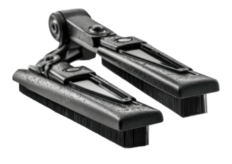 Folding tool brush, metal, hinge. High angle shot against black