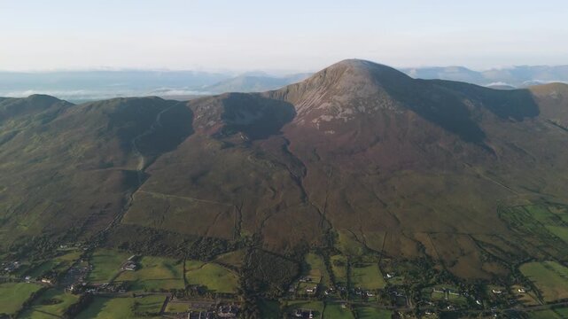 Amazing 4K aerial video of flying above and around Most Famous mountain in Ireland - Croagh Patrick in windy weather, with moving fog and clouds with breathtaking views around, Westport, Ireland