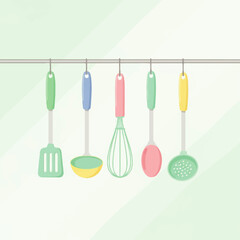 Collection of hanging kitchen utensils in a light green kitchen background, perfect for culinary projects