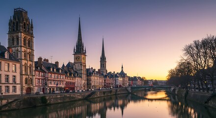Fototapeta premium Cityscape at dusk featuring architecture river towers and sunset colors