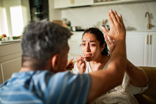 Middle aged couple arguing at home