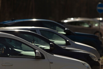 Fototapeta premium cars rest peacefully, quiet cars settle at dusk, silent automobiles peacefully settle under evening sunset glow, tranquil vehicles are peacefully parked in soft glow of setting sun