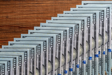 Background of many american one hundred dollar banknotes. A pile of new one hundred US dollars. Cash of hundred dollar bills, closeup