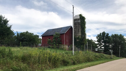 Red Barn with Silo with Growth on the SIde
