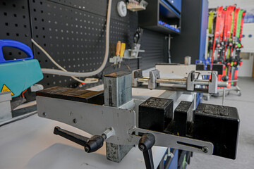Ski repair workbench with precision tools for winter sport equipment service