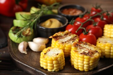 Vegetarian barbeque. Tasty grilled vegetables served on wooden table, closeup