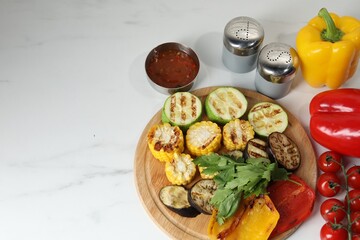 Vegetarian barbeque. Tasty grilled vegetables served on white marble table, flat lay. Space for text