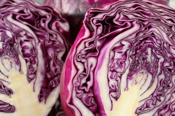 Obraz premium Cut red cabbage as background, closeup view