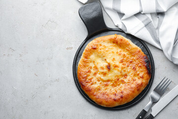 Delicious Megrelian khachapuri served on grey table, top view. Space for text