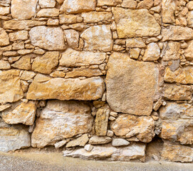 Old stone wall texture made of irregular blocks