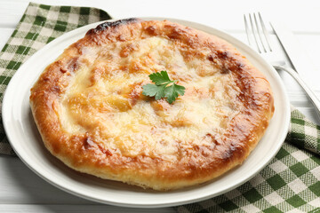 Delicious Megrelian khachapuri served on white wooden table, closeup
