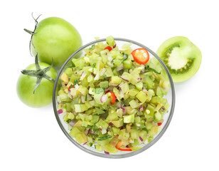 Tasty salsa in bowl and green tomatoes isolated on white, top view
