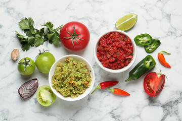 Tasty salsa in bowl and ingredients on white marble table, flat lay