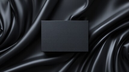 black box on dark silk fabric