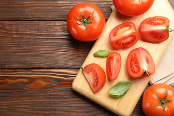 Fresh ripe tomatoes and basil on wooden table, flat lay. Space for text