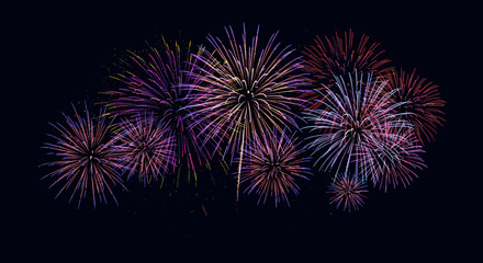 Vibrant fireworks display against night sky with multicolored bursts