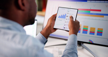 Smart Black Businessman Predicts Market Performance Through Analytics