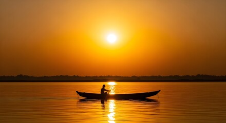 Silhouette of a Fisherman or Person in a Rowboat on Calm Water Against a Golden Sunset or Sunrise