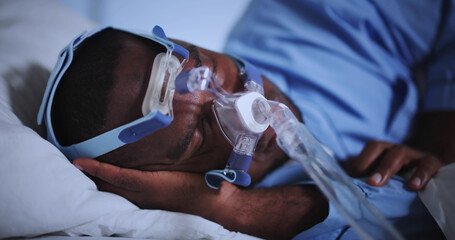 Asleep Noisy African American Man Wearing Sleep Apnea CPAP