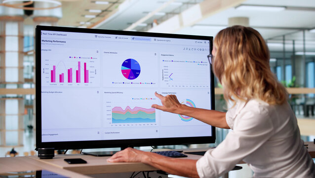 Office Desktop With Computer Displaying Business Analytics - Powered by Adobe