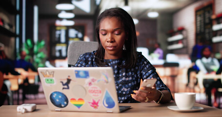 African American Woman Planning Budget At Coffee Shop