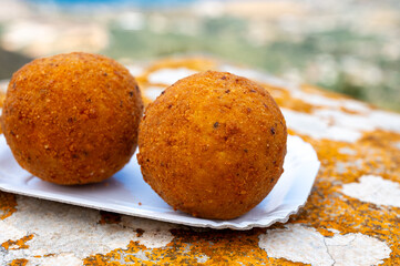 Arancini Sicilian, deep-fried rice balls made with risotto, filled with ingredients mozzarella,...