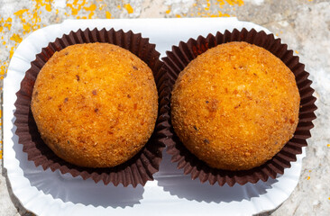Arancini Sicilian, deep-fried rice balls made with risotto, filled with ingredients mozzarella,...