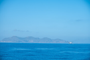 Boat trip from Trapani with view of fort, blue water and fisherman's boats, travel destination on Sicily, Italy
