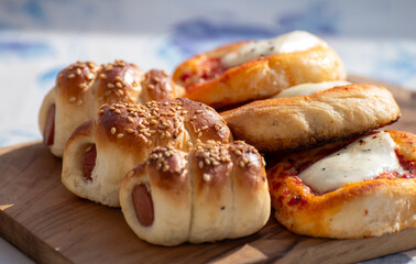 Fresh baked bread, pizza, focaccia or pizzetta with tomatoes, vegetables, sausage and cheese, street food in Palermo, Sicily, Italy, served outdoor for lunch