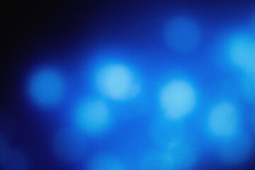 Soft blue illumination with cinematic blur and grainy dust overlay, creating an elegant modern background texture for design, film, and digital art projects