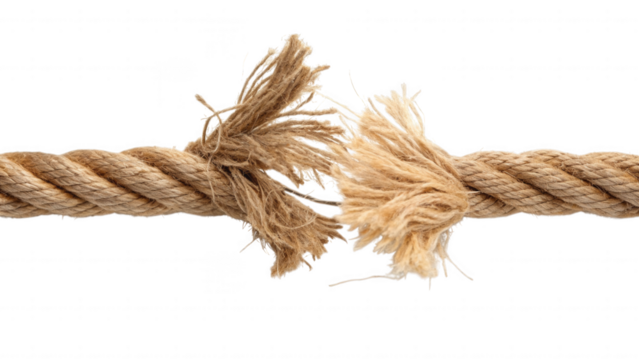 Close up of a frayed rope breaking apart against a black background