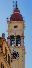 Close-up of the iconic yellow and red bell tower in Corfu, a historical landmark of the Greek...