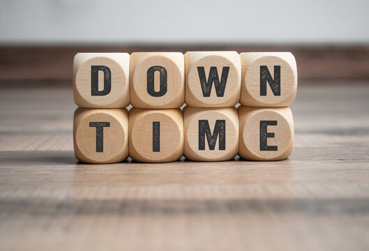 Cubes, dice or blocks with word downtime on wodden background