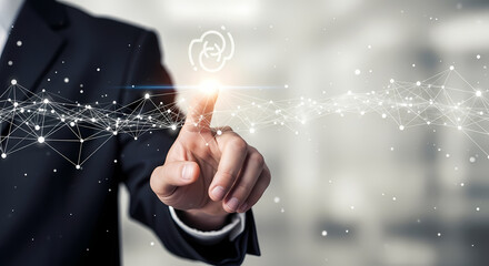 A businessman's finger touches a digital cloud icon, symbolizing data storage and technology advancements in a modern business setting.