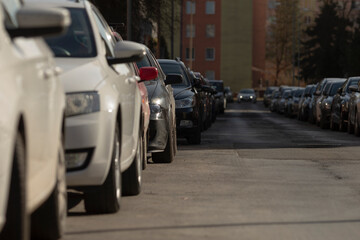repetitive wheel arches in residential parking lots, orderly suburban parking captured from lowangle perspective, lowangle shot highlighting symmetrical and repetitive elements in suburban parking