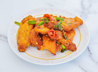 Crispy garlic fried pork, vibrant with red chili and green onions, tempts the taste buds! Perfect for culinary blogs, restaurant menus, or healthy eating campaigns