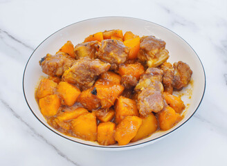tender pork ribs paired with sweet potato in a rich savory sauce. Perfect for showcasing delicious home-style cooking. A comforting and appetizing meal idea.