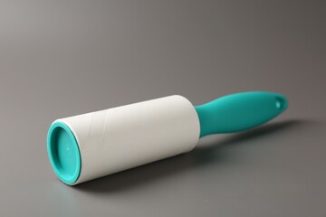 One lint roller on grey background, closeup